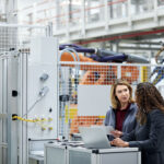 female engineers using technologies in car plant