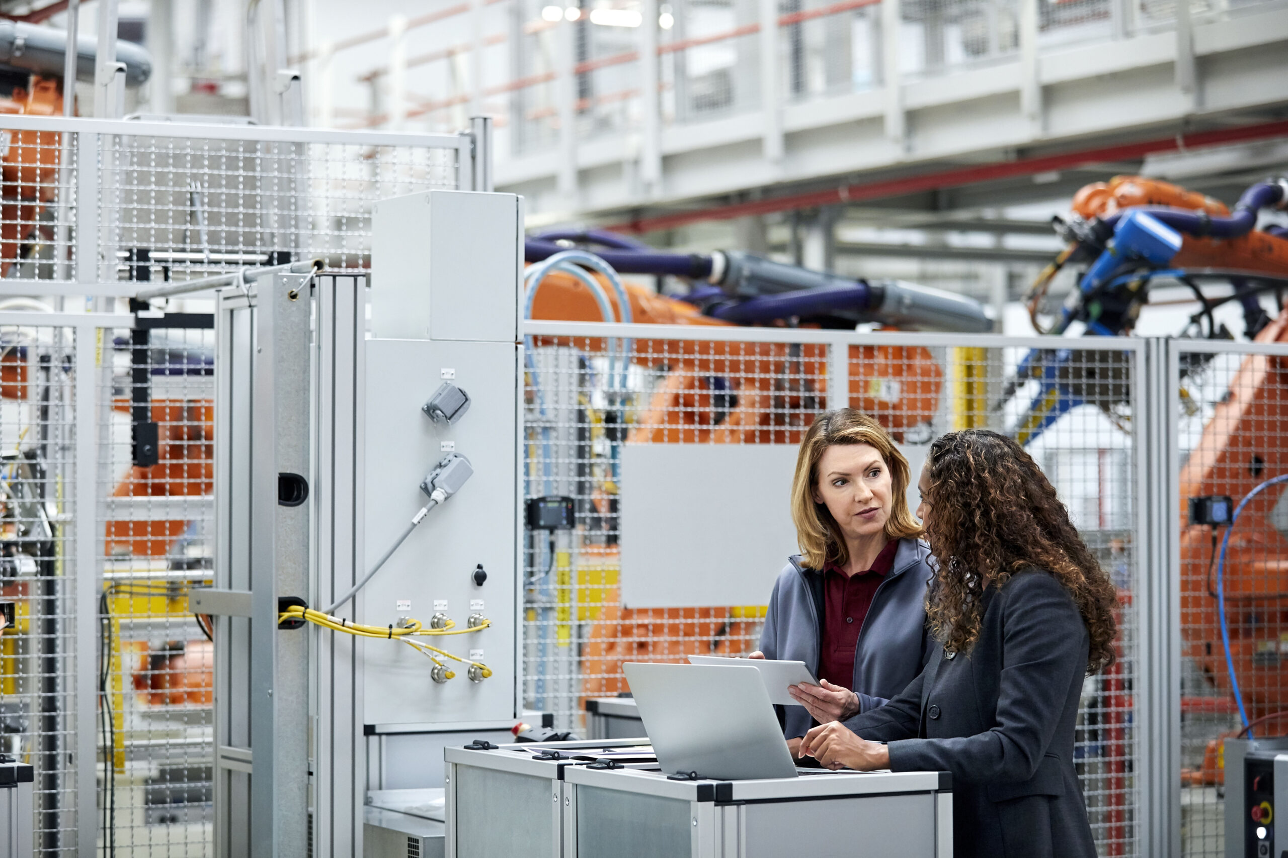 female engineers using technologies in car plant