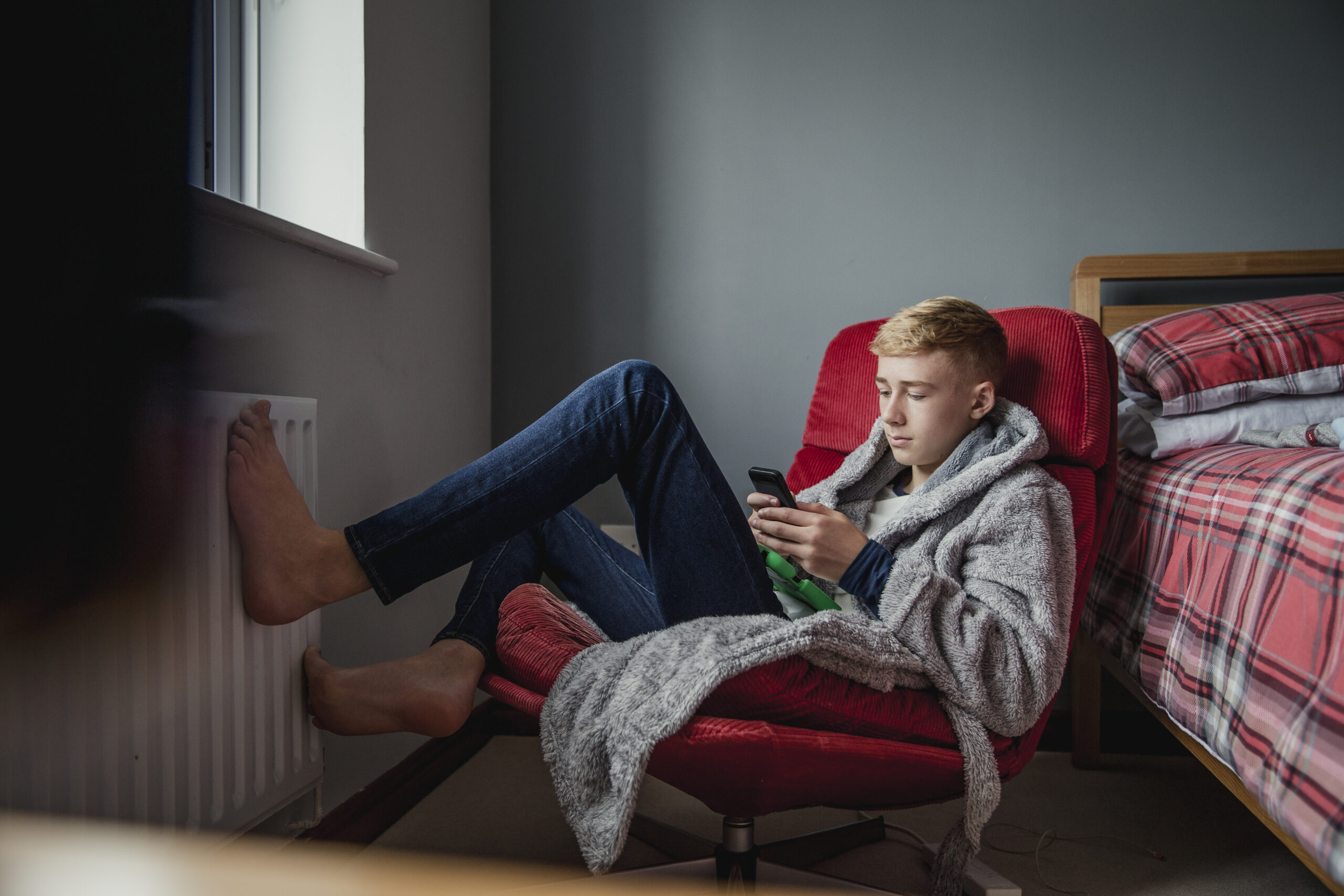 teenage boy relaxing in his bedroom